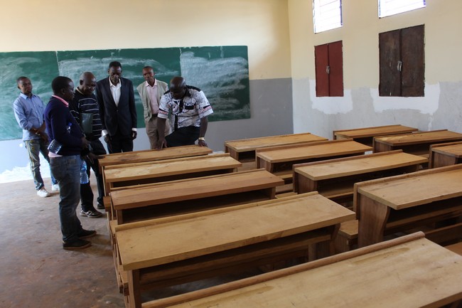Des bancs fraichement fabriqués placés dans une salle de classe