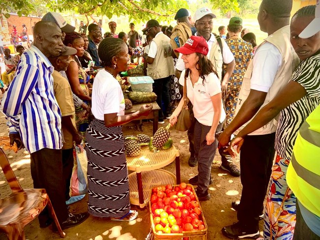 Mme Martha, SG de Caritas Norvège, achetant avec joie des produits des bénéficiaires